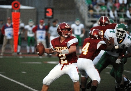 Newport senior quarterback Ross Quarre looks for a receiver downfield in the season-opening loss to Woodinville Friday night in Bellevue. Quarre passed for 117 yards