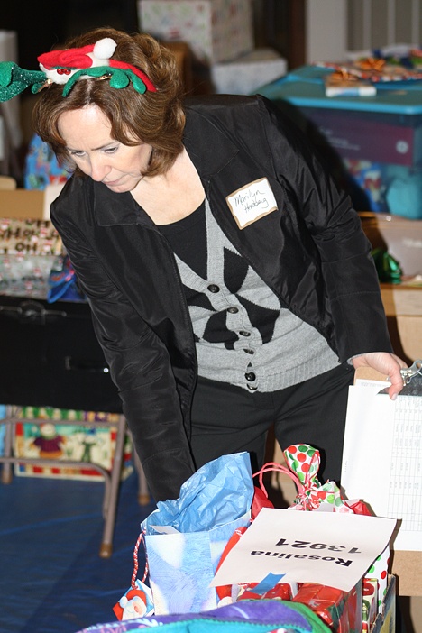 Adopt-a-Family Chairman Marilyn Herzberg joined volunteers on Wednesday at Overlake Service League's distribution center