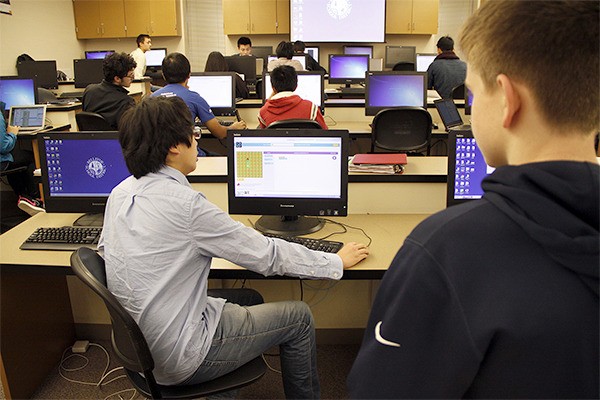 Bellevue High School senior Louis Hong explains basic computer coding.