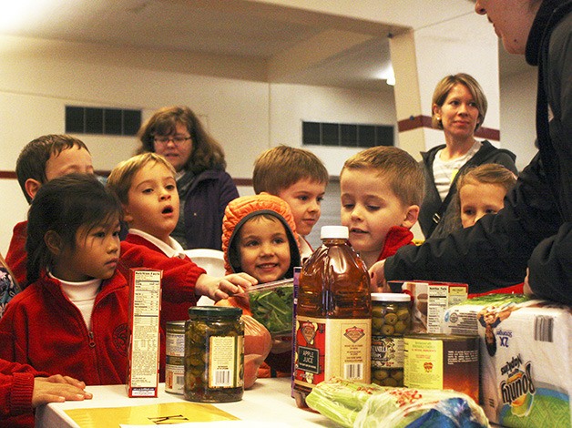 First graders at St. Louise School deliver donated food that were organized in baskets to deliver to those in need on Thanksgiving. Over 27 complete Thanksgiving meals were delivered to both St. Vincent de Paul and Catholic Community Services. The annual project between the parish and the school has been conducted for over 20 years.