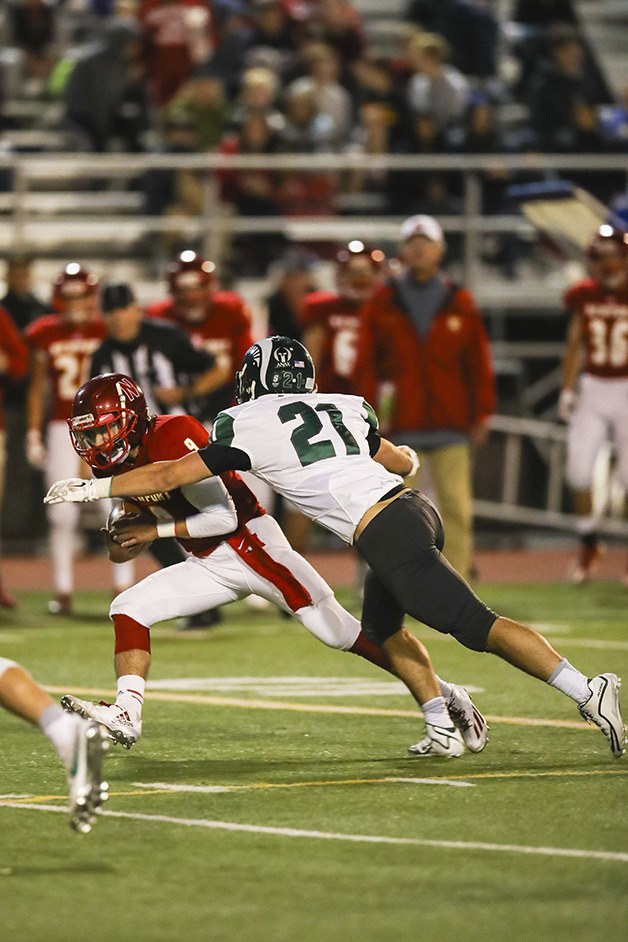 Newport Knights quarterback Brandon Steinberg scrambles for yardage before being tackled by Skyline defensive back Jack McCarthy on Sept. 23 at Newport High School.