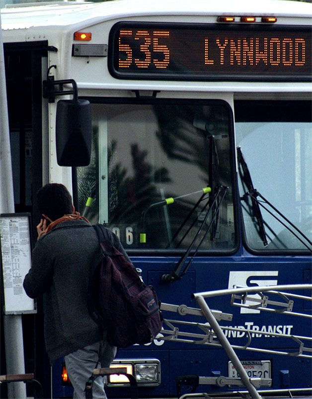 A Sound Transit rider prepares to board a bus at the Bellevue Transit Center on Wednesday (Jan. 15).