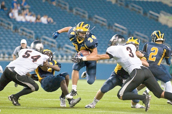 Joey Mangialardi (34) breaks through the Union defense during Bellevue's 20-6 win over the Titans at Qwest Field Saturday night.