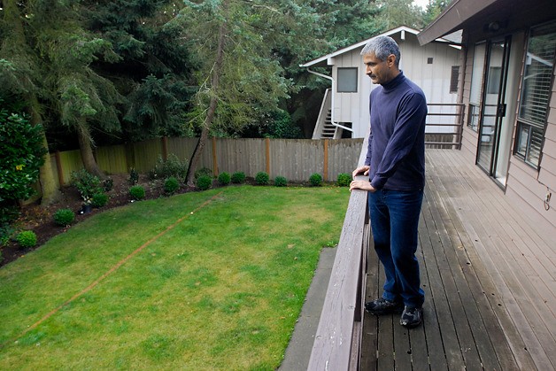 Arjun Sirohi looks at red a line painted through his backyard that he says is one of the options Sound Transit sees for its light-rail line.