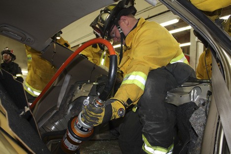Bellevue firefighter Keith Schaff works with extrication equipment during a training event Wednesday at Precision Collision in Bellevue.