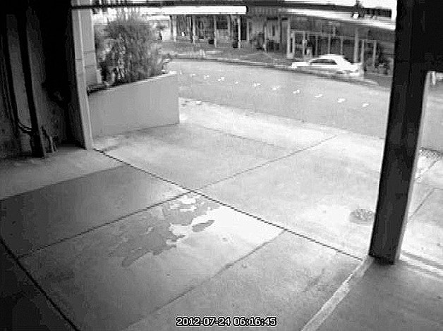 A security camera shows a silver 4-door Mitsubishi with a rear spoiler at the burglary scene.