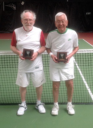 Alan Woog (left) and Yutaka Kobayashi show their tennis trophies.