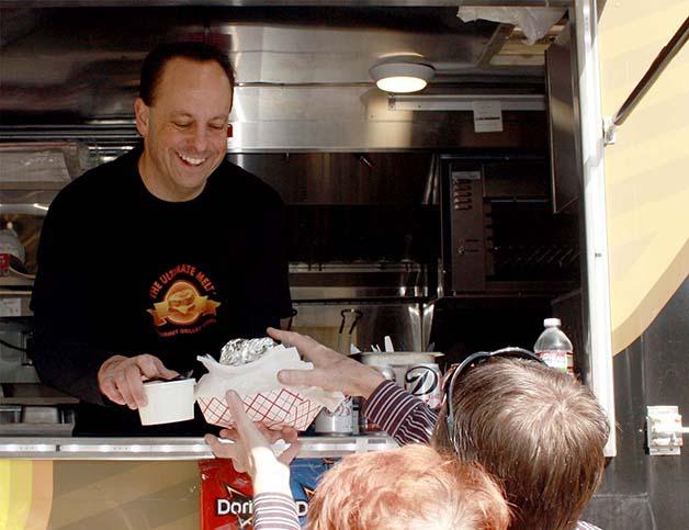 The Ultimate Melt owner Greg Wagner serves up grilled cheese and soup in the Verizon Wireless parking lot in Bellevue on Friday