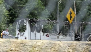 A shell is all that remains of a bus gutted by fire.