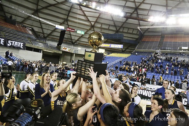 The Bellevue Wolverines girls basketball team hoists the “Gold Ball” after capturing the Class 3A state basketball title with a 69-40 win against the Arlington Eagles on March 5 at the Tacoma Dome. Bellevue finished the 2015-16 season with an overall record of 29-0.