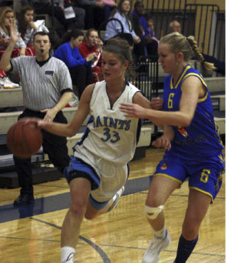 Interlake’s Sarah Anderegg (33) drives past a Norwegian player. Anderegg scored 22 points to lead the Saints to a 45-43 victory.