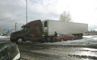 A semi truck is stuck on the I-405 offramp onto Northeast Eighth Street on Monday