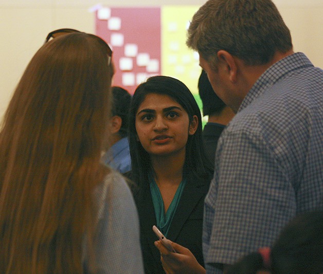 Amrita Ram explains her company's EcoBoard product to attendees of the Youth Entrepreneurs Academy pitch event