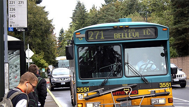 Bellevue College students hop on the King County Metro bus on campus Wednesday. The college is spending up to $200