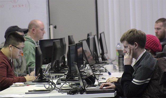 Coding Dojo students work on their computer programming language skills at the boot camp's new headquarters in downtown Bellevue on Thursday