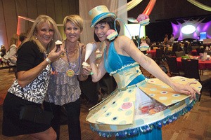 Sarah Langton and Trinity Parker pose with a performer at the KidsQuest Children's Museum carnival Oct. 1.