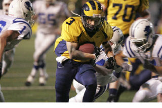 Bellevue junior running back Freddie Levine charges forward in the Wolverines win over Sedro-Woolley on Saturday night. Levine scored two touchdowns and was one of 11 Bellevue players to rush the football.