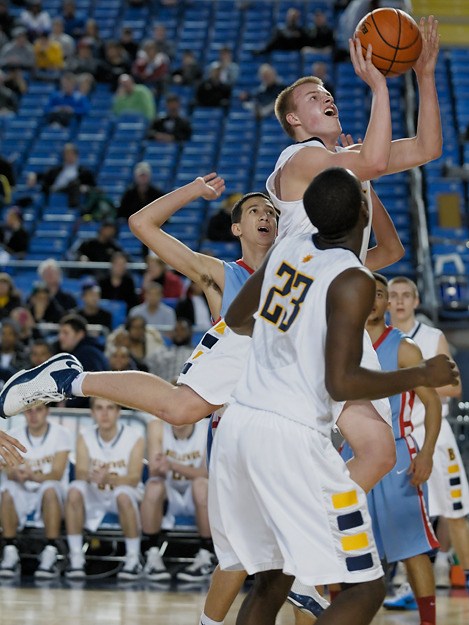 Bellevue forward Nate Sikma scores two of his 15 points to lead the Wolverines to a come form behind win over Chief Sealth during WIAA 3A state tournament play at the Tacoma dome on Thursday.