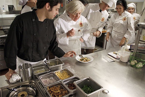 Newport High School's culinary teacher Tracy Green (center) samples her former student