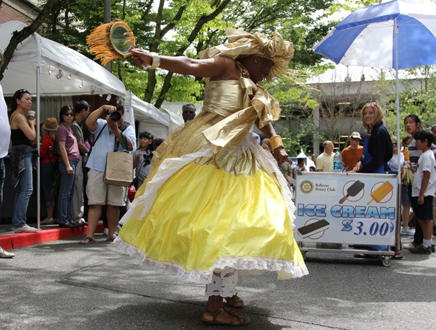 A woman dances at the Bellevue Arts Fair in downtown as a part of the festival attractions.