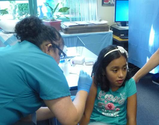 Jennifer Betancourt receives her free flu shot Oct. 3 at Stevenson Elementary School in Bellevue as part of an effort by Molina Healthcare in partnership with Bellevue School District
