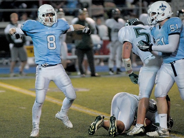 Saints linebacker Jacob Marks (8) celebrates a sack of Port Angeles quarterback Keenen Walker during a playoff game at Interlake on Friday. Interlake won 47-26.