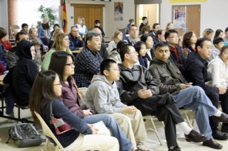 400 students signed up for about 80 openings in Bellevue’s International School.  Left: anxious parents and their children watch as names are drawn in a lottery Feb. 11 for the open spots.