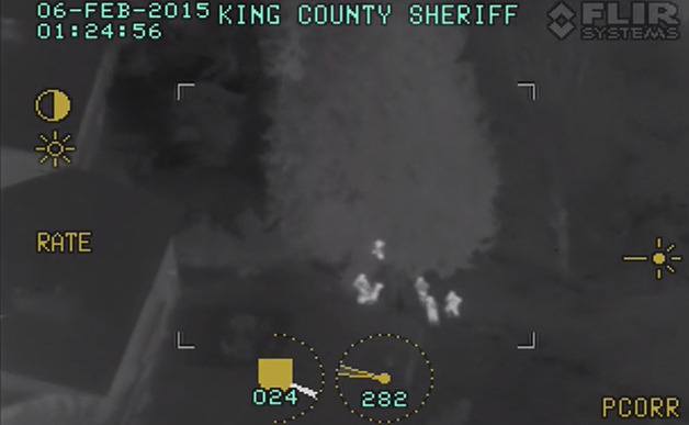This screen shot from a thermal imaging camera used by King County Sheriff's Air Support shows officers arresting two assault suspects early Friday morning
