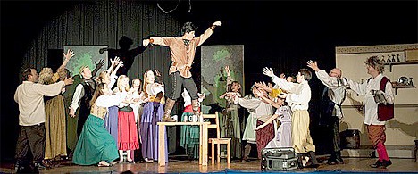 New York Times' best-selling author Robert Dugoni (on platform) plays Gaston in Sacred Heart's rendition of Disney's 'Beauty and the Beast.'
