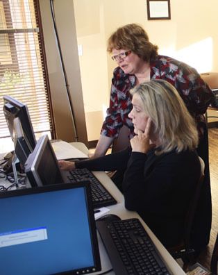 Bellevue resident Aida Wittenmeyer works on her application at the Walmart hiring center in Bellevue Monday afternoon.