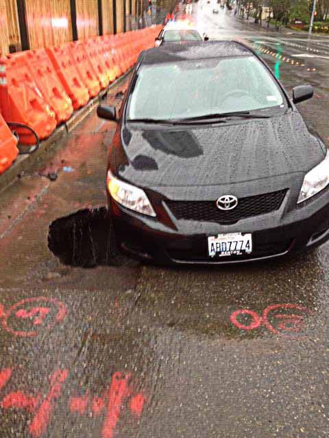 A sinkhole that opened up on Northeast Fourth Street in downtown Bellevue on March 15 was determined to have been caused by water backing up on the road
