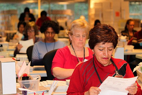 Election workers begin preparing ballots for counting Tuesday