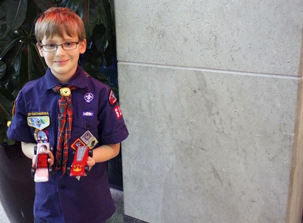 Cub Scout Weston Hunt shows off his winning cars - 'Silver Bullet' and 'Red Lightning.'