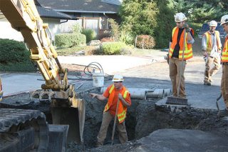 A city of Bellevue Water Department crew begins repair of a broken water main in the Somerset Woods neighborhood Monday