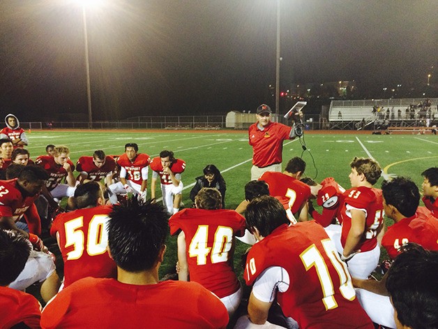 Newport Knights head coach Drew Oliver delivers his post game speech following Newport's 58-30 win against the Inglemoor Vikings on Sept. 25 at Newport High School in Factoria.