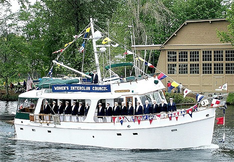 Boaters stand at attention as they pass the reviewing stand on opening day of boating season. The group wom second placein the category of Best Dressed Power boat.