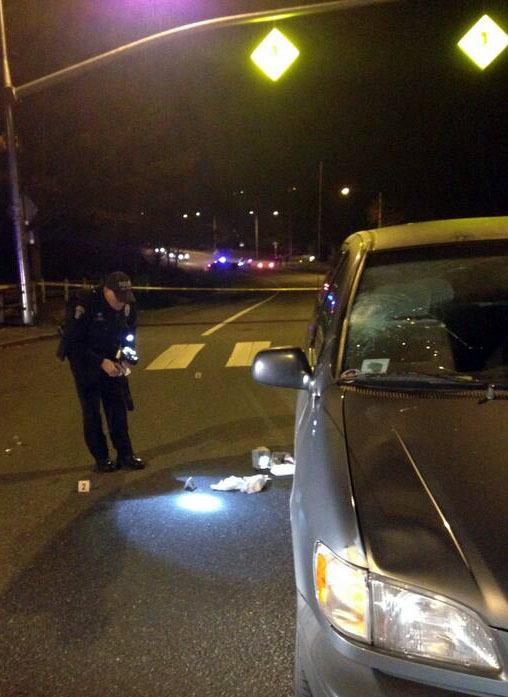 A Bellevue Police officer collects evidence at a vehicle-versus-pedestrian collision on Forest Drive Wednesday night.