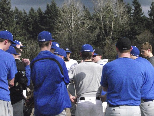 Bellevue Christian players listen as head coach Brian Potoshnik speaks during practice.