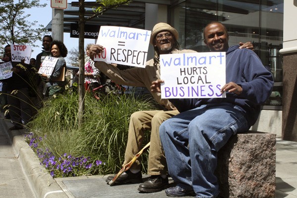RJ Williams (left) and Gerald Hankerson (right) participate in an anti-Walmart protest outside the Bellevue Hyatt May 17. 'Walmart destroyed my childhood city in Louisiana