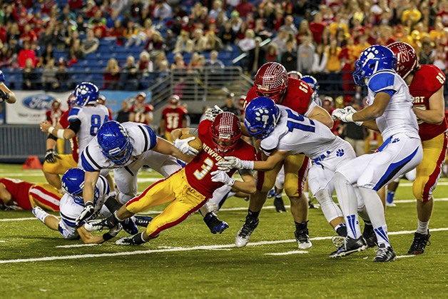 Newport Knights running back Thomas Day battles for extra yardage against the Bothell Cougars in the Class 4A state semifinals on Nov. 29 at the Tacoma Dome.