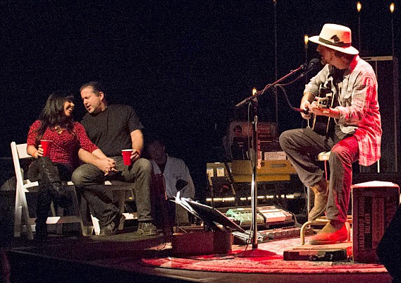 Pearl Jam frontman Eddie Vedder serenades auction winners Tom Moran and his wife Val Cole during a benefit show earlier this month. All the money raised went to fund EB research.