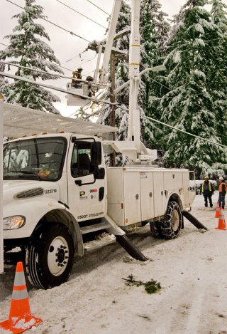 Puget Sound Energy crews repair a South Bellevue line following the snow fall on Sunday