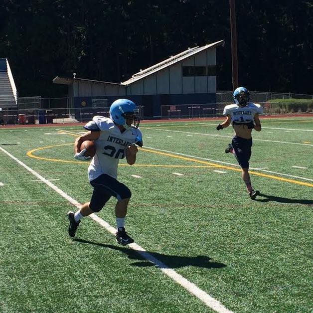 Interlake running back Max Collins sprints up the field after hauling in a swing pass during a spring football practice session on June 8 at Interlake High School in Bellevue.