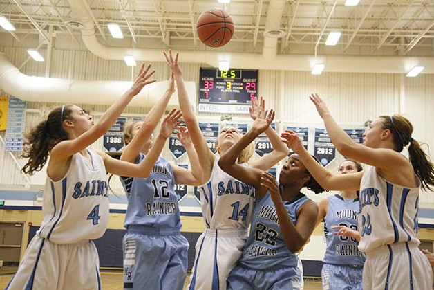 Players from both the Interlake Saints and Mount Rainier Rams girls basketball teams battle for a rebound in the closing seconds of the third quarter on Jan. 2 at Interlake High School.