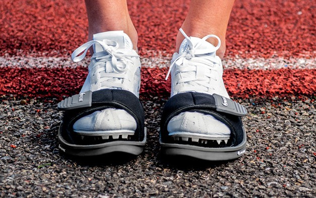 Spikease straps over an athlete's track spikes