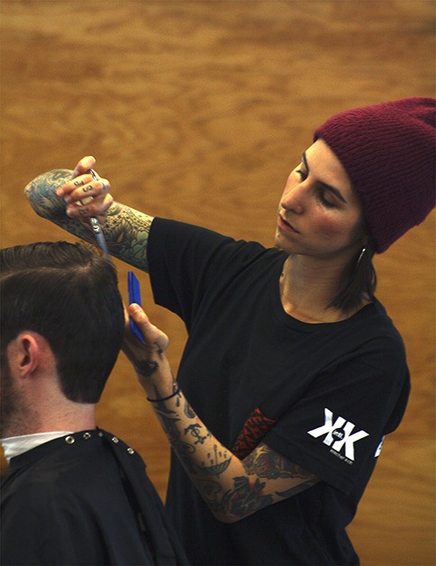 A stylist works on a man’s haircut at Rudy’s Barbershop in Bellevue