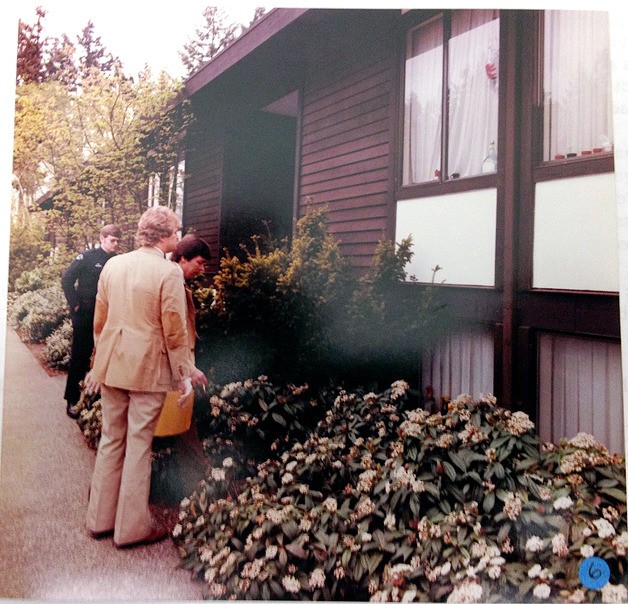 Two Bellevue Police Department detectives and a patrol officer investigate outside the apartment of Susan Lowe in April 1980.