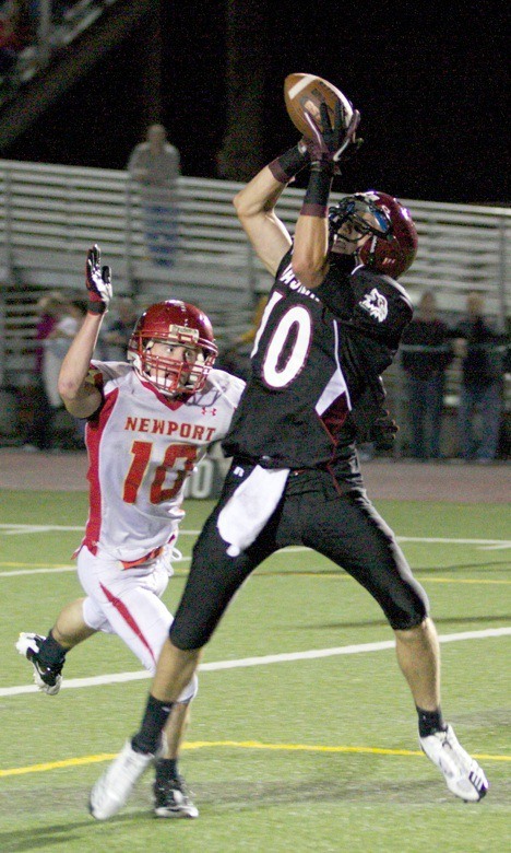 Newport defensive back Kevin Martin can't stop 6-foot-6 Eastlake wide receiver Colin Nelson from hauling in a 25-yard touchdown pass from Keegan Kemp. The Wolves won 34-21.