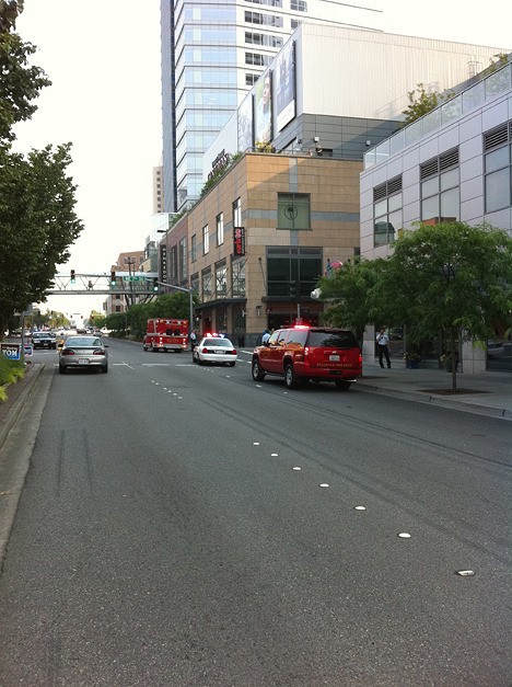 Bellevue Police Officers canvas the area after a 24-year-old man jumped to his death at Lincoln Square on August 5.