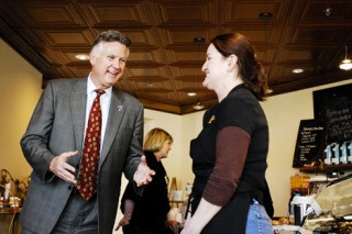 King County Council member Larry Phillips shares a laugh with business owner Sandra Wixon at Sweet Decadence Chocolates in Newcastle on April 16. Phillips is running for the King County Executive seat and met with community leaders to talk about their concerns.